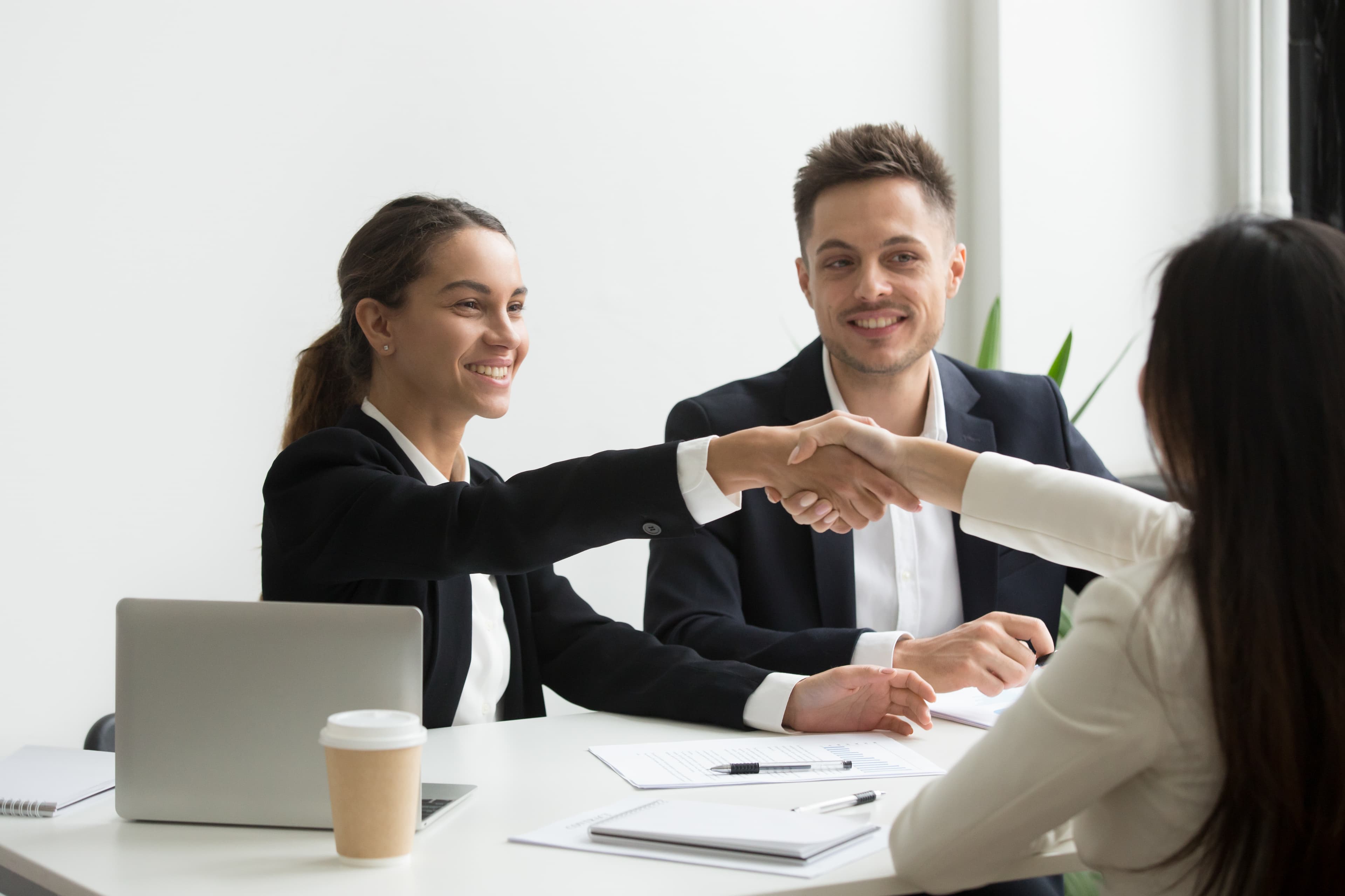 A recruiter shaking hands with a new hire
